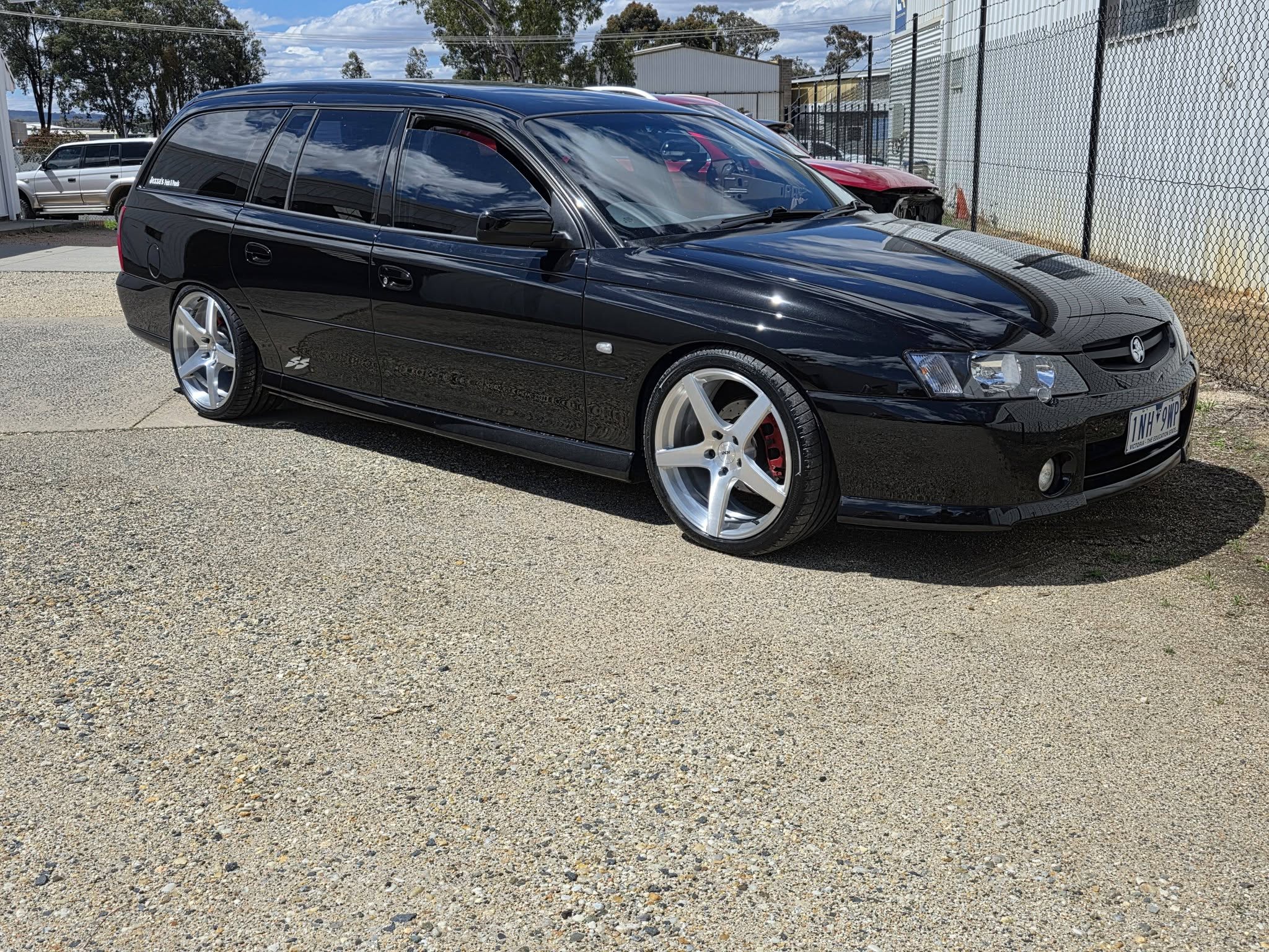 Gloss black Holden VY SS wagon with a deep paint finish
